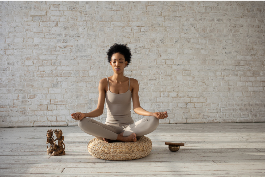 Woman meditating to deal with stress at work.