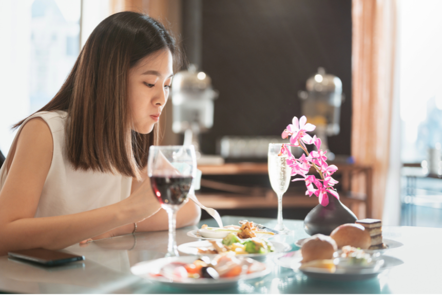 A woman savoring a plate of exquisite food.