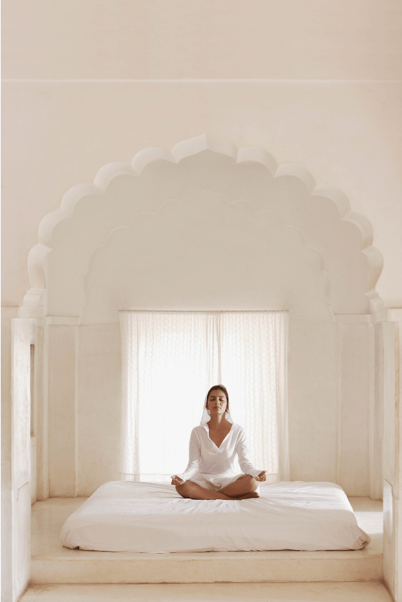 A woman is meditating for higher performace.