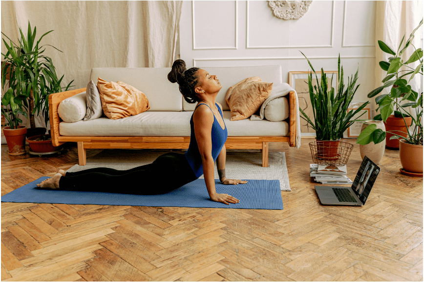 A woman doing a yoga workout at home.