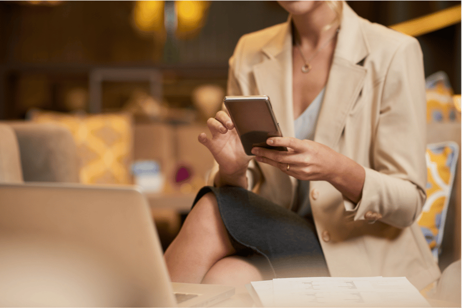 A career woman checking emails on her phone.