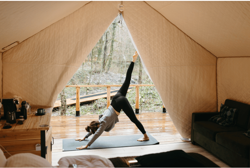 A woman doing yoga at a burnout retreat.