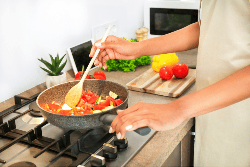 A woman cooking with single ingredient foods.