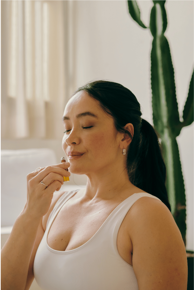 A woman using essential oils from her stress relief kit